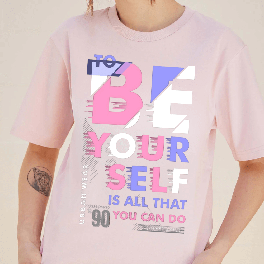 Oversized pink tee featuring 'To Be Yourself' typography, 90s-inspired style, unisex fit, and ethically sourced fabric.