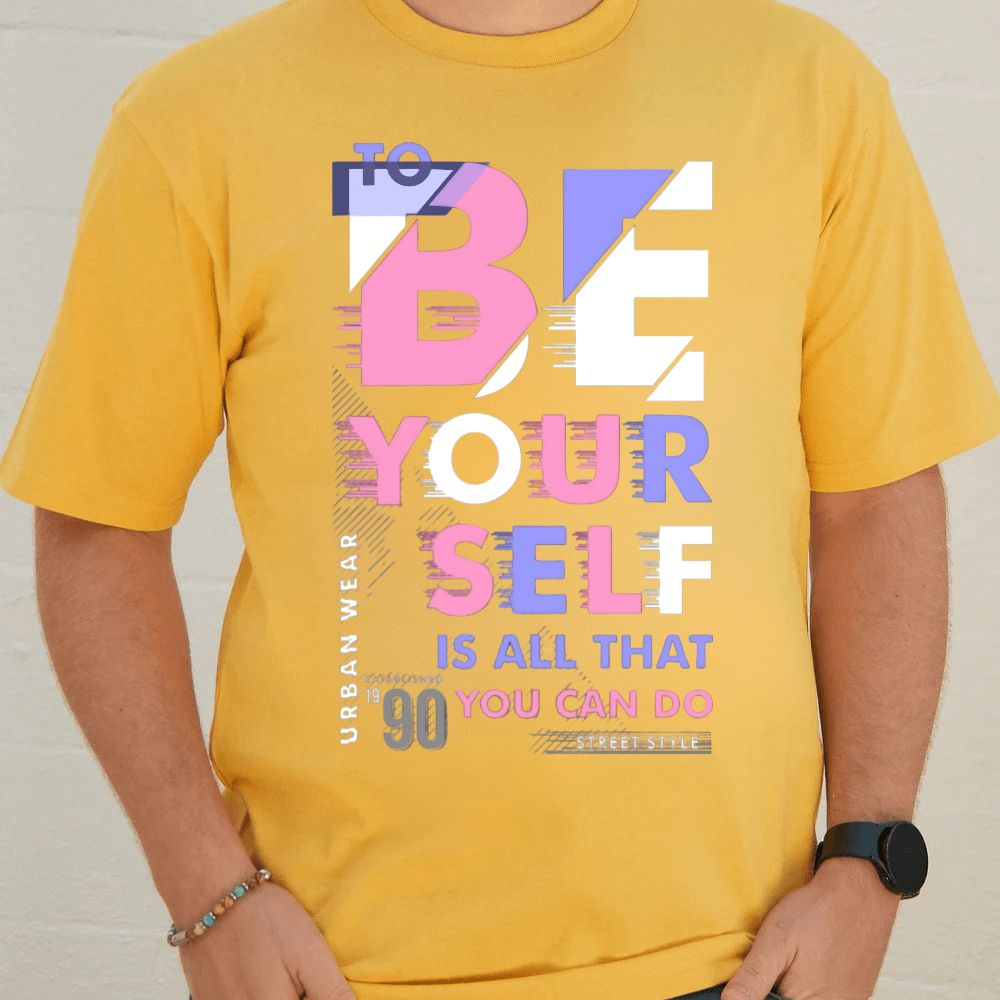 Yellow oversized graphic tee with 'To BE YOUR SELF' slogan and 90s-inspired design, unisex and ethically sourced.