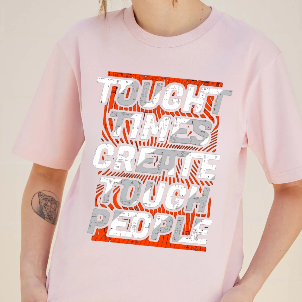 Person wearing a pink t-shirt with motivational text design on a plain background
