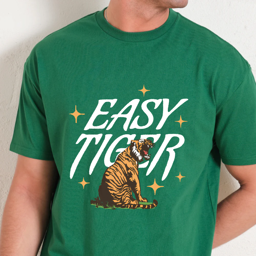 Green t-shirt with 'Easy Tiger' graphic design on a plain background