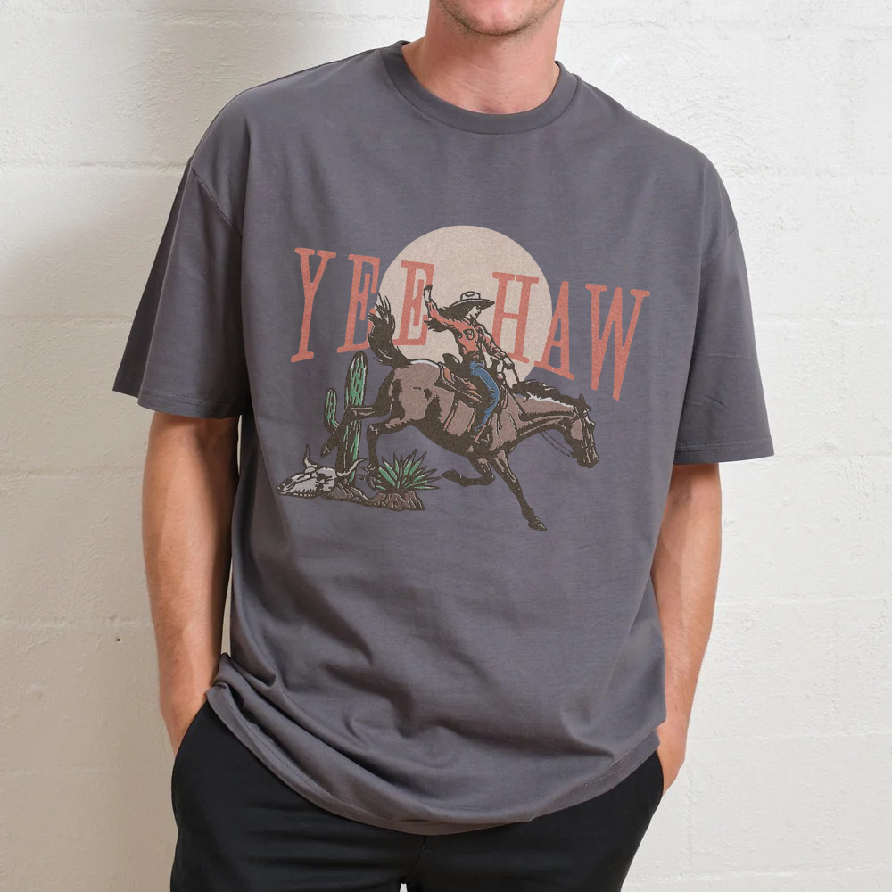 Person wearing a gray t-shirt with a cowboy graphic and 'Yee Haw' text.