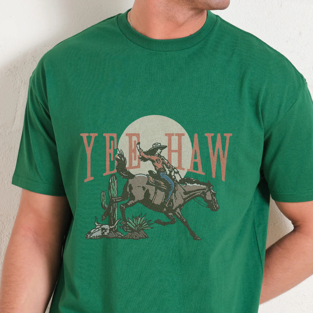 Green t-shirt with a cowboy graphic and 'Yee Haw' text on a plain background