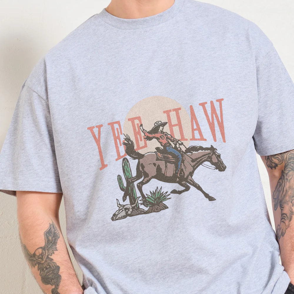Gray t-shirt with a graphic of a cowboy on a horse and 'Yee Haw' text.