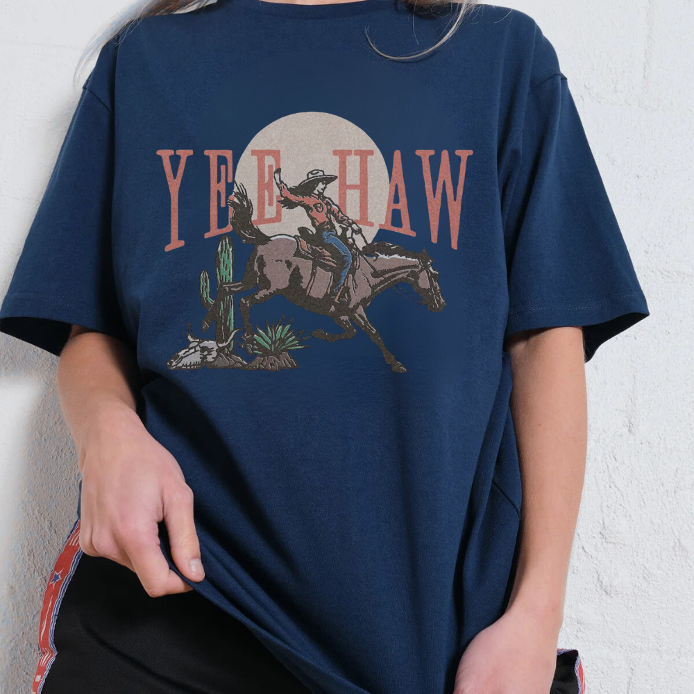 Navy blue t-shirt with a graphic of a cowboy on a horse and 'YEE HAW' text against a white background.