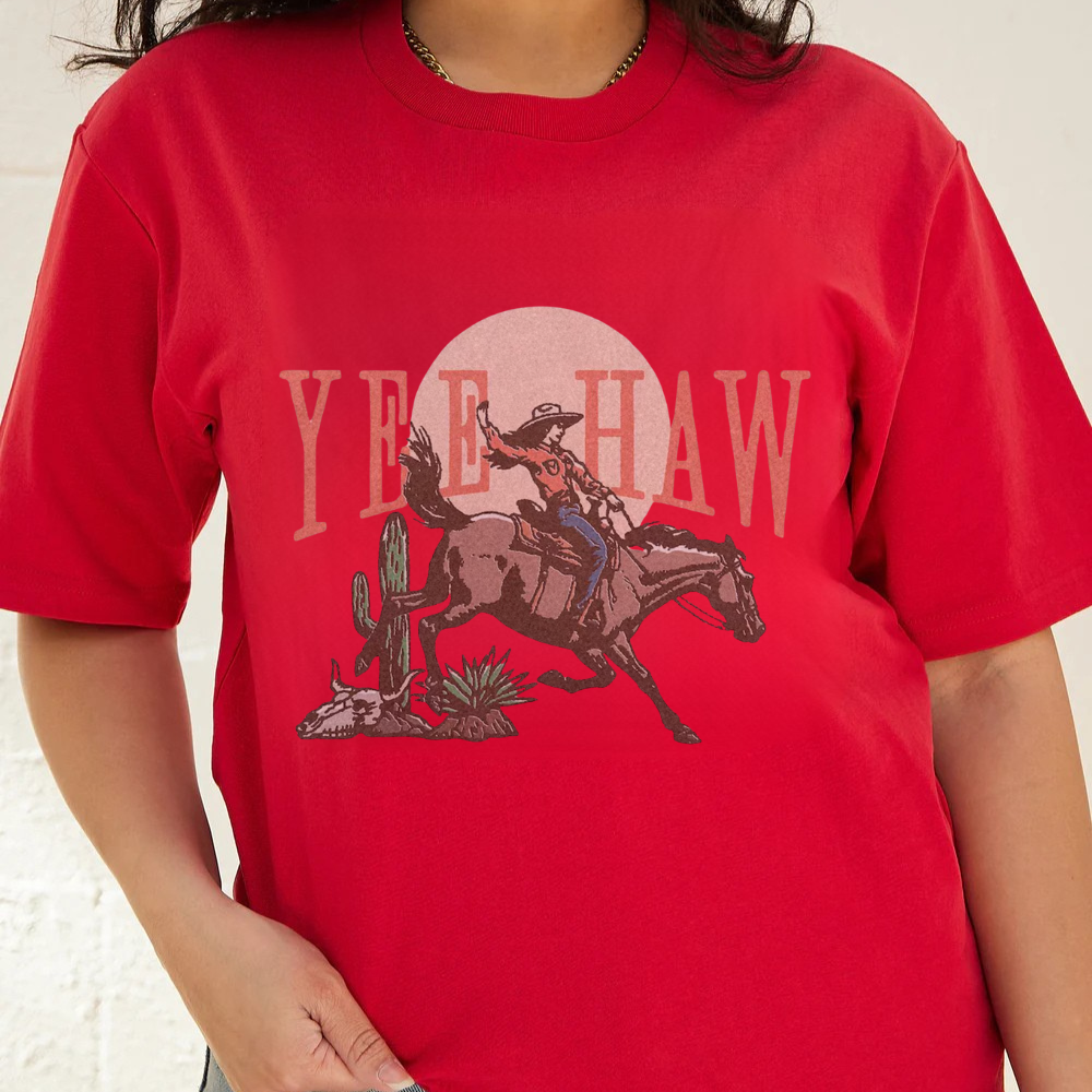 Red t-shirt with a graphic of a cowboy on a horse and 'Yee Haw' text.
